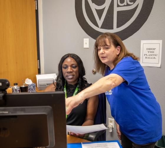 Admin VSO Header Two women pointing at a computer screen