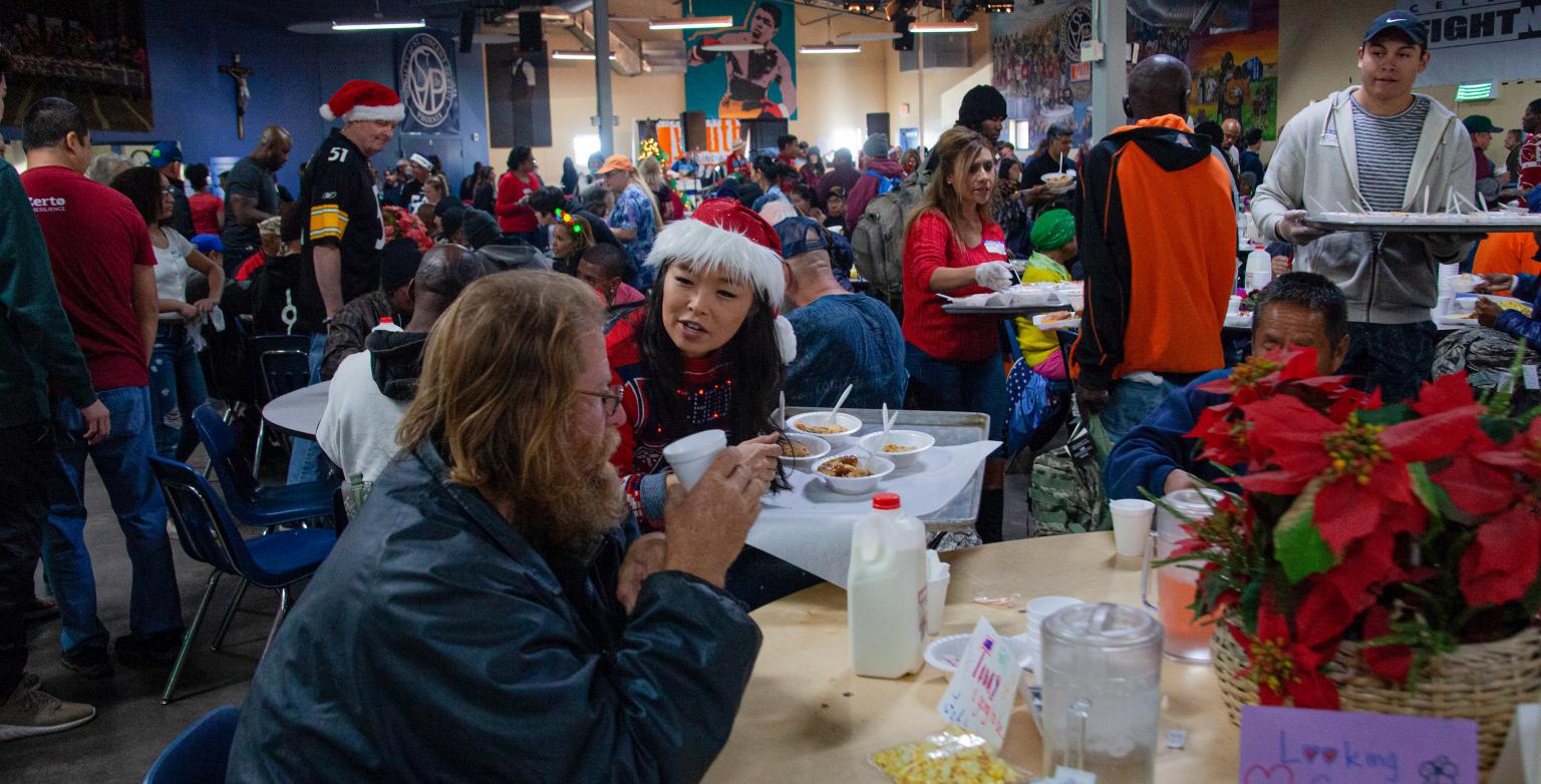 Christmas Volunteer handing out hot meal