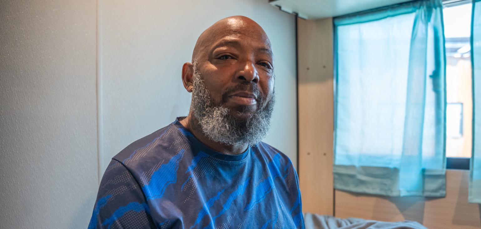 Dennis Robinson sits in his room in the X-WING at SVdP's Washington Street Shelter.