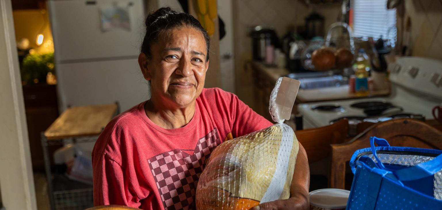 Margarita holds her Turkey from SVdP.