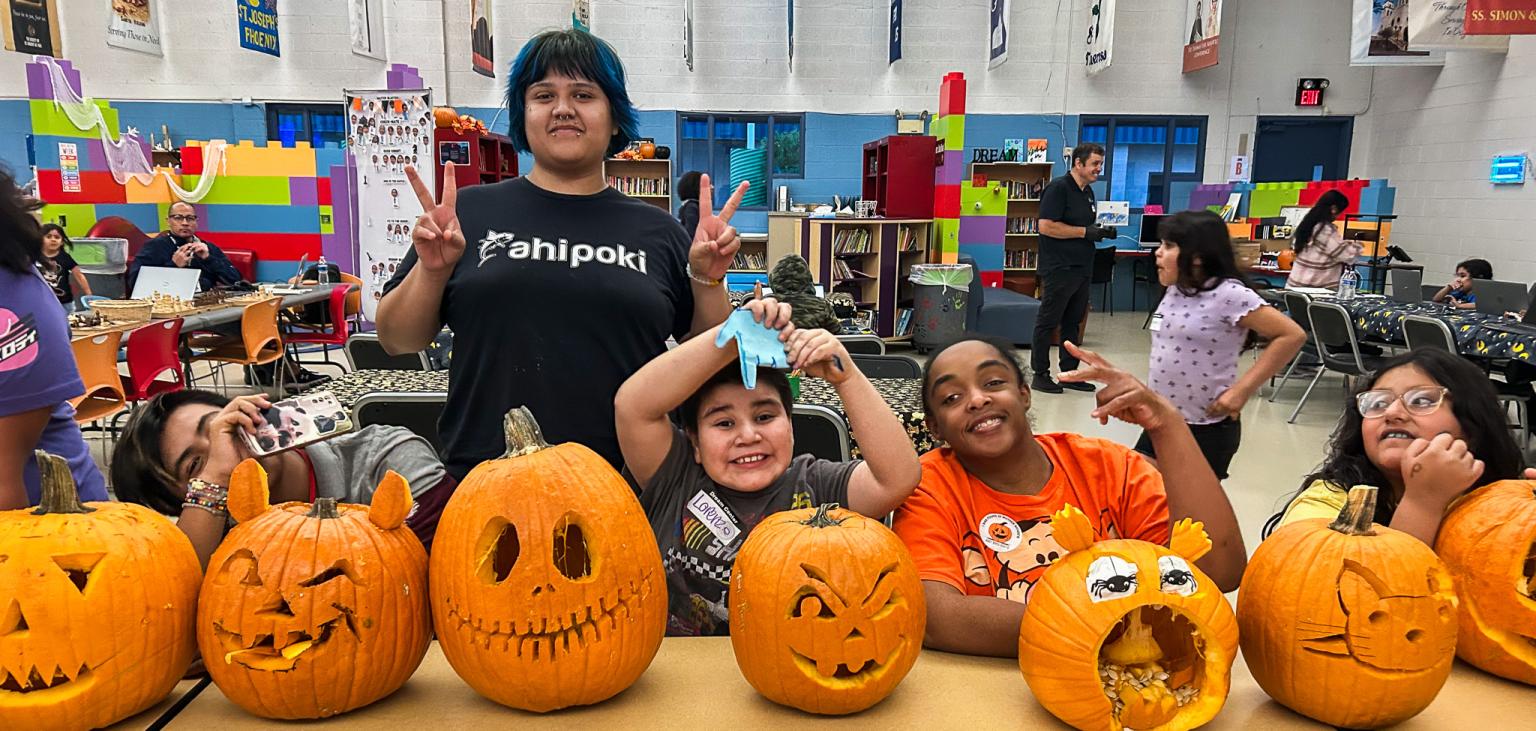 Guests line their pumpkins up for judging in the pumpkin carving contest.