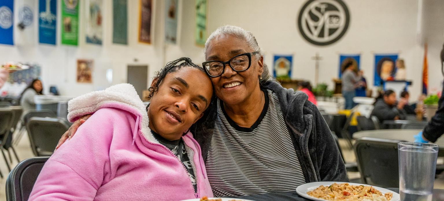 Kenya and Shay enjoy a meal at SVdP's Family Evening Meal.