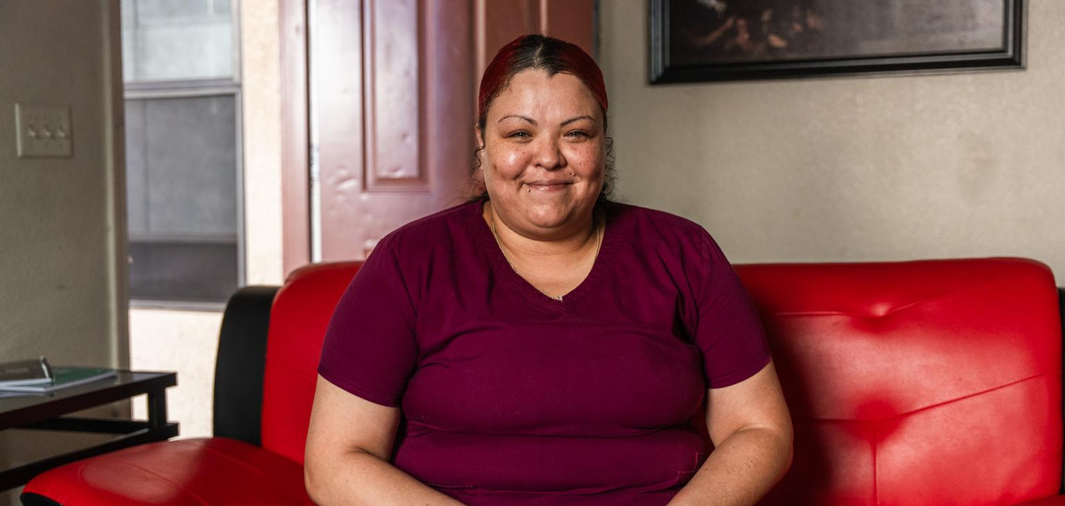 Angela Bryant smiles for a photo in her home.