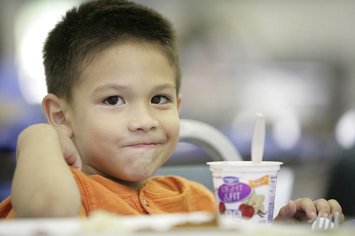 A child eats dinner in St. Vincent de Paul's dining room.