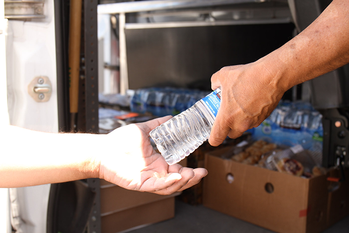 Handing out water to the homeless