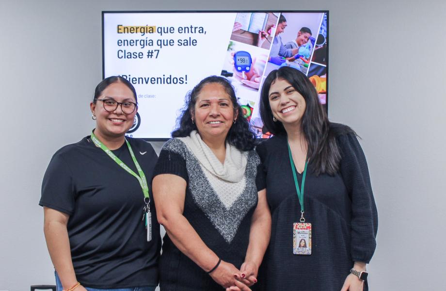 Maria stands with the course instructors from SVdP.