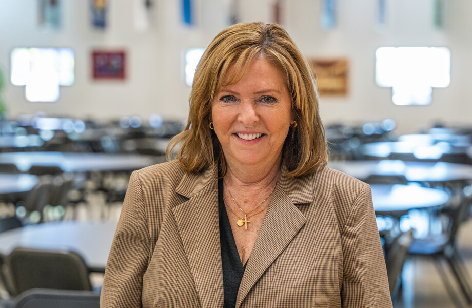 Libby Ekre poses in SVdP's Hall of Banners.