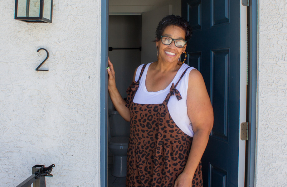 Annamarie in front of her new home.