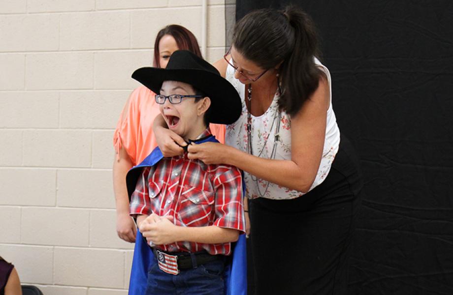 Austin Dorcey receives superhero cape and award at St. Vincent de Paul.