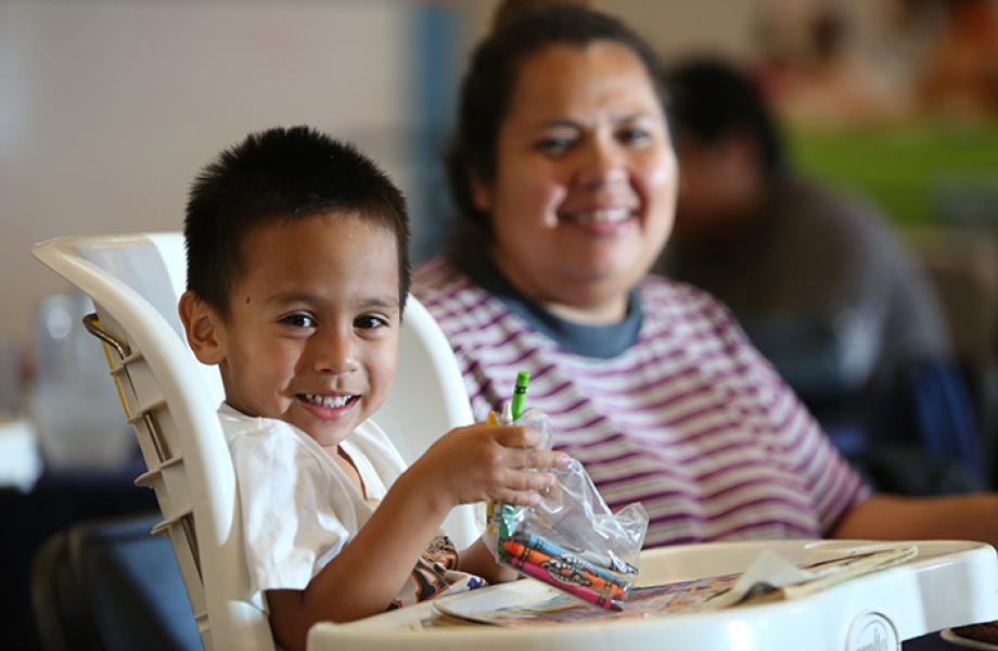 A child eats dinner in St. Vincent de Paul's dining room.