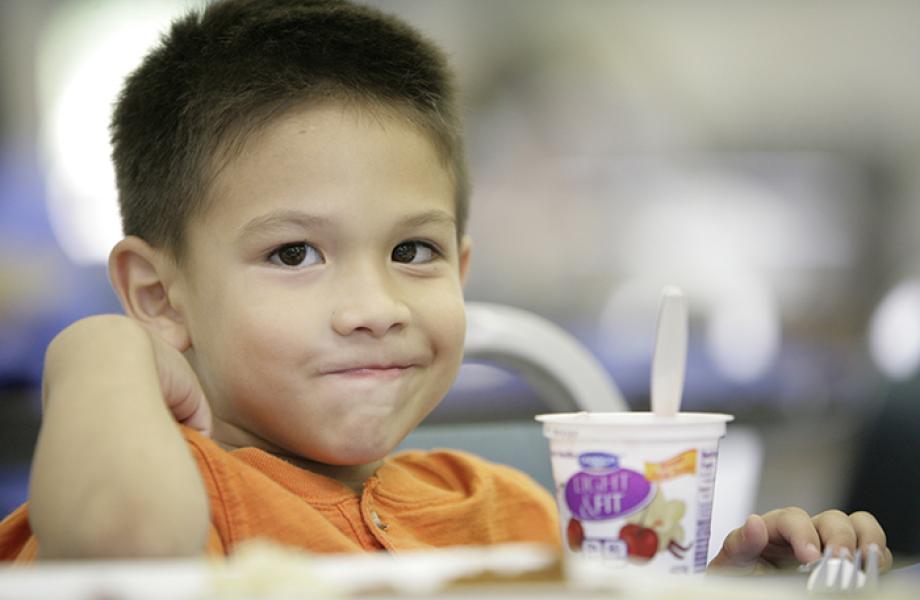 A child eats dinner in St. Vincent de Paul's dining room.