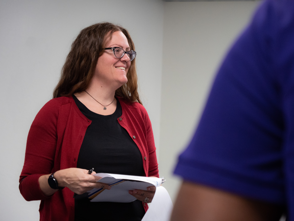 Woman holding paper and smiling