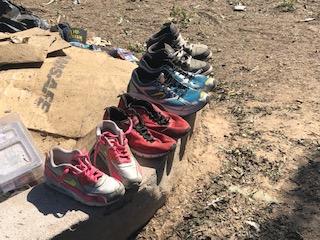 Shoes lined up on a curb