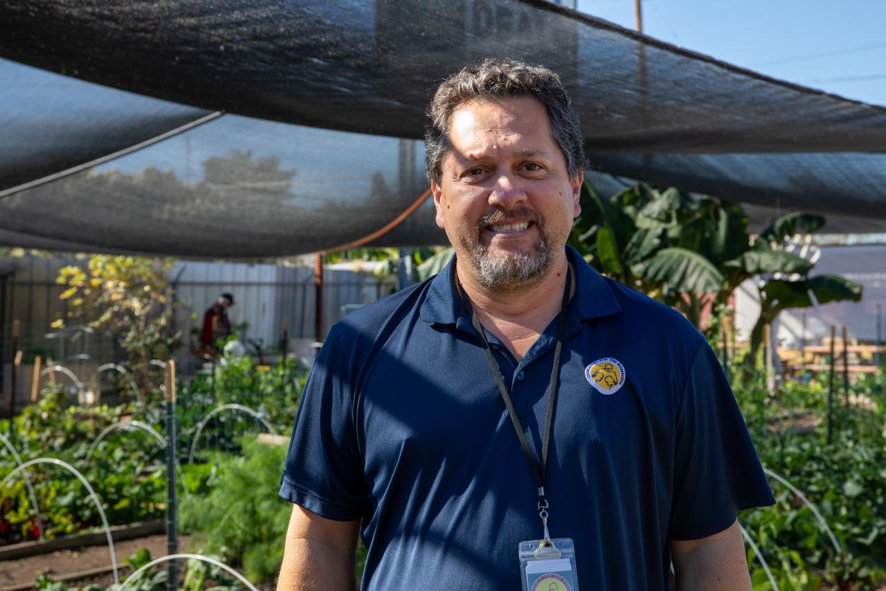 Charles Gonzalez posing in the Mesa Urban Farm