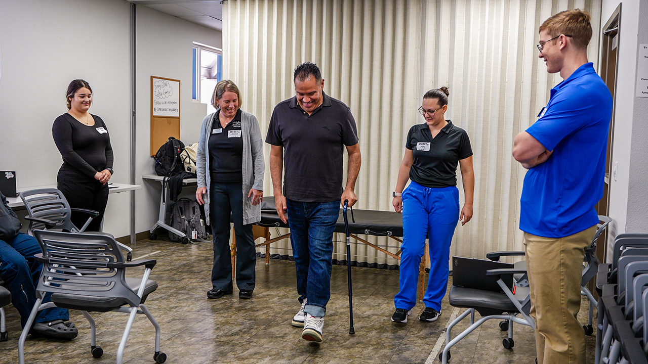 Luis practices walking during one of his physical therapy sessions with Creighton University Doctor of Physical Therapy students volunteering and gaining field experience at SVdP's Virginia G. Piper Medical Clinic.