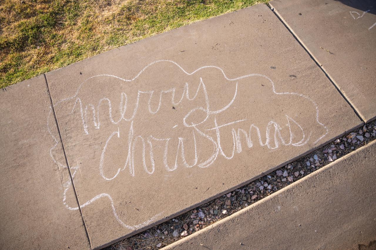 A chalk message written in front of Christin and Keira's house reading, "Merry Christmas."