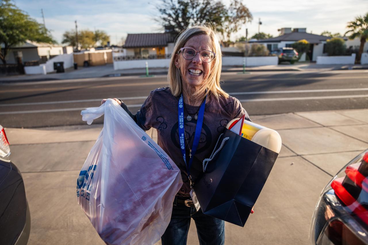 Lynn brings in a bag of presents and other helpful supplies.