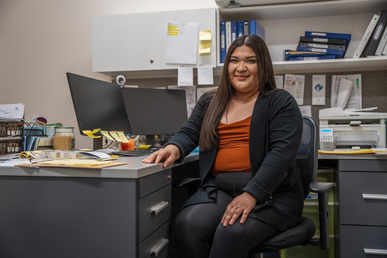 Emily Perales, one of SVdP's social workers, sits at her desk.