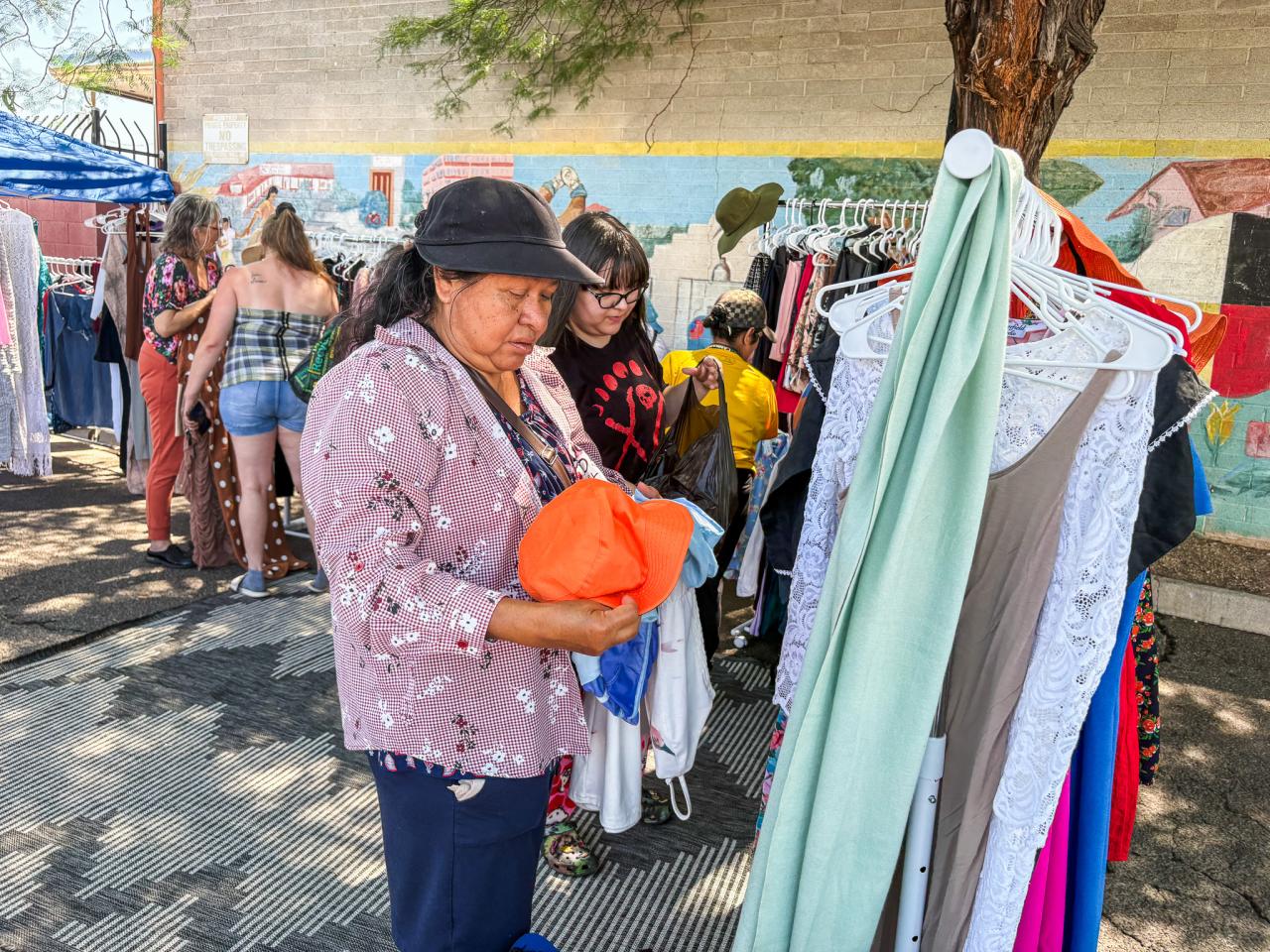 Women pick out fits at the event.