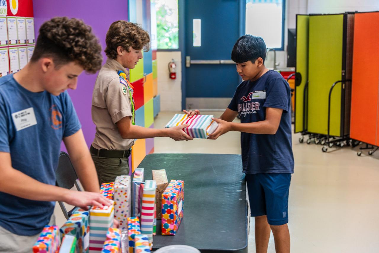 Wilder hands a young guest a Lego set.