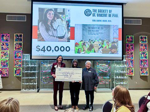 Donors from the Board of Visitors pose with SVdP CEO Shannon Clancy as they award SVdP $40,000.