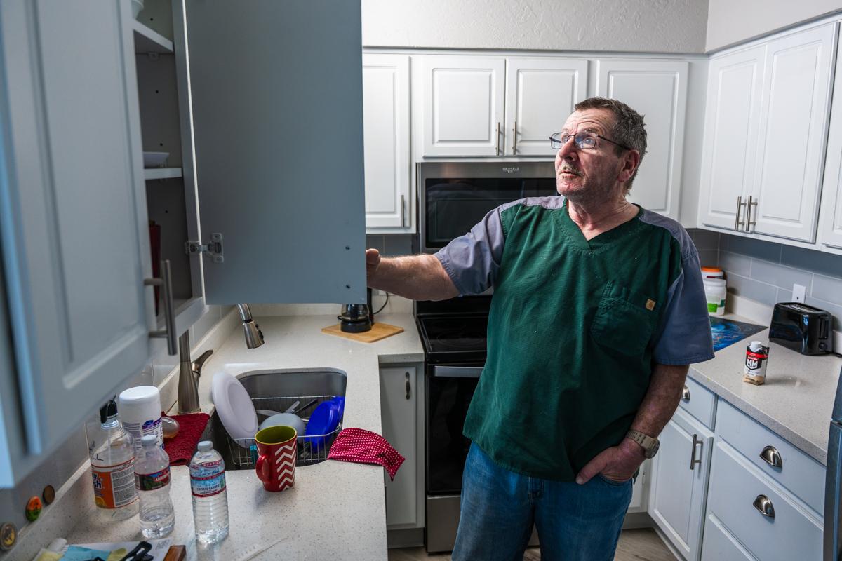 Christopher Riley in his apartment's kitchen.