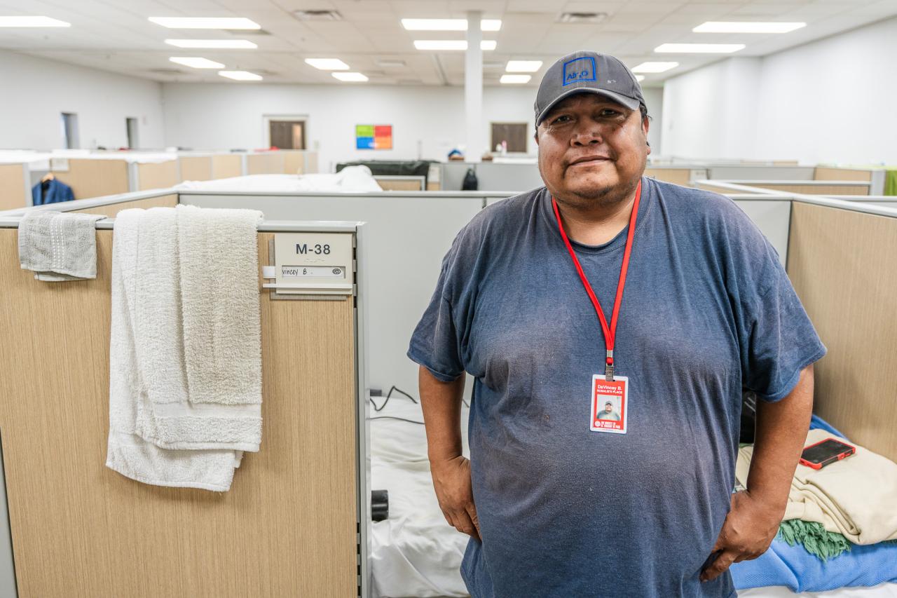Davincy stands next to his bed.