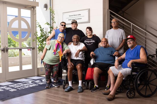 Oz residents posing in the lobby of Ozanam Manor